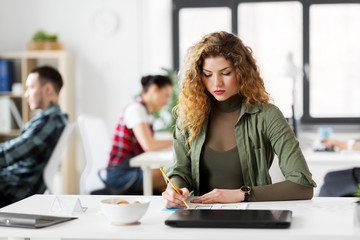 business, technology and people concept - creative woman or developer working on user interface design at office