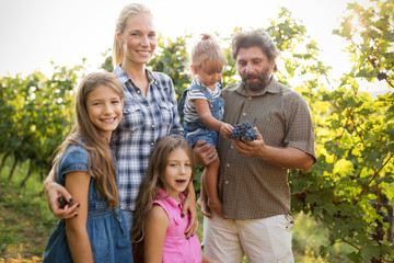 Winemaker family together in vineyard