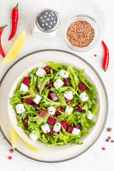 Salad with lettuce, boiled beets, feta cheese, flax seeds and lemon