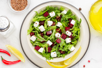 Salad with lettuce, boiled beets, feta cheese, flax seeds and lemon
