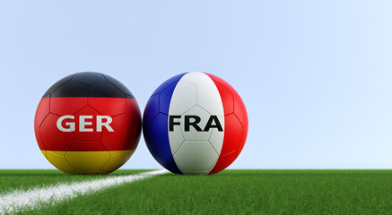 Germany vs. France Soccer Match - Soccer balls in German and France national colors on a soccer field. Copy space on the right side - 3D Rendering 