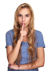 Fototapeta premium Young woman holding a finger on her lips