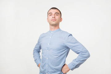 Handsome young man standing like a super hero