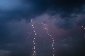 The discharge of lightning in the sky as a background