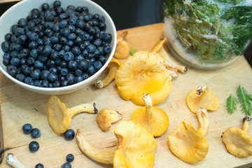 wintering on the wooden plate: blueberries, pine and mushrooms