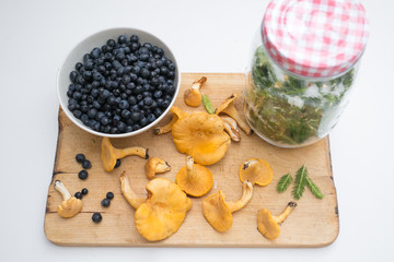 wintering on the wooden plate: blueberries, pine and mushrooms