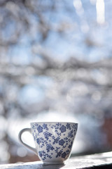 A Cup of hot tea standing in the street. Time of year - winter. Frost and steam from the Cup