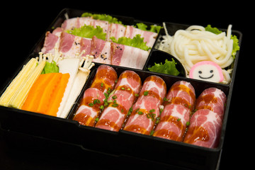 Korea Food in Restaurant, Fresh Sliced Pork set and Mixed Vegetable set in black background.