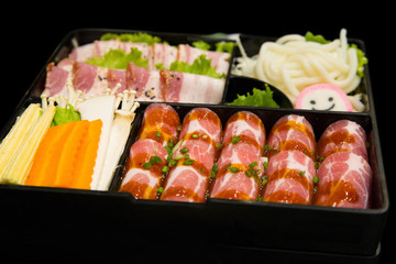 Korea Food in Restaurant, Fresh Sliced Pork set and Mixed Vegetable set in black background.