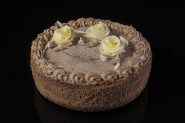 Obraz na płótnie Canvas Chocolate cake with cream on a black background