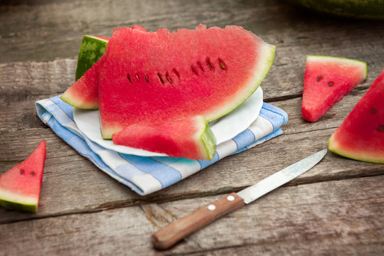 Slices of watermelon on plate with cutlery