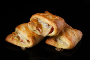 Puff pastry with meat and cheese on a dark background