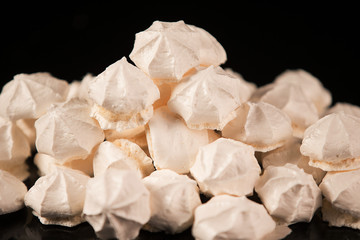 Meringue cookies close-up on a black background