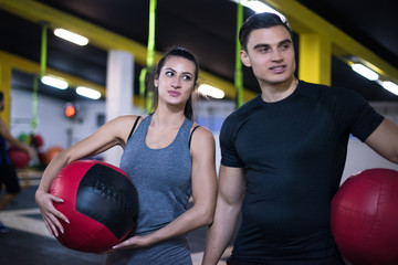 young athletes couple working out with medical ball