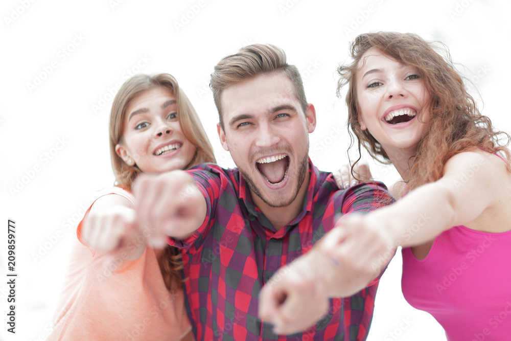 Wall mural closeup of three happy young people showing hands forward