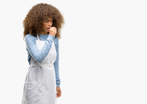 African american shop owner woman wearing an apron sick and coughing, suffering asthma or bronchitis, medicine concept