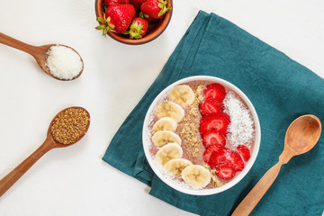 Organic superfood bowl with banana, strawberry, flax seed and coconut. Vegan