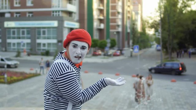 Mime gesticulate hands and has fun on camera
