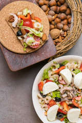 healthy protein salad with shrimps, tomatoes, avokado, lettuce, oil, olives in high protein biscuits. Wooden background. Vegan food. Protein source