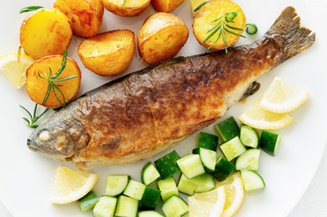 freshwater trout with jacket potatoes and cucumber salad