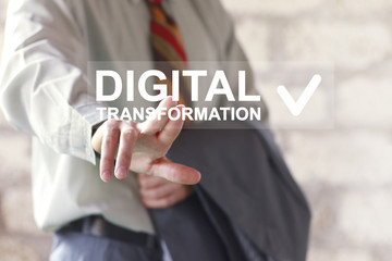 Businessman pressing an interface with the text digital transformation. Concept of digitization of business processes online.