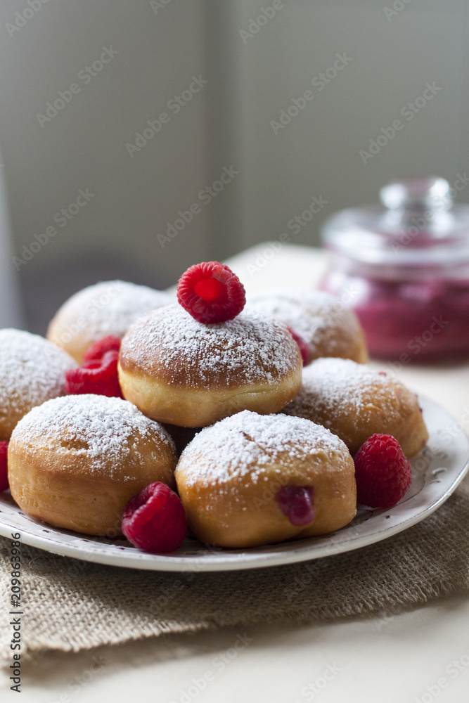 Sticker Breakfast with Krapfen (or berliner, or doughnut, or bombolone) made from yeast dough fried, with berry curd filling, powdered conventional sugar on top.