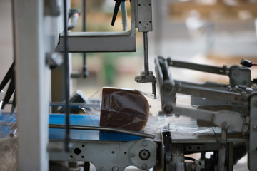 Industrial line for packaging of bakery products. Packing of bread at the factory.The machine for cutting and packing in a factory for the production of bread.