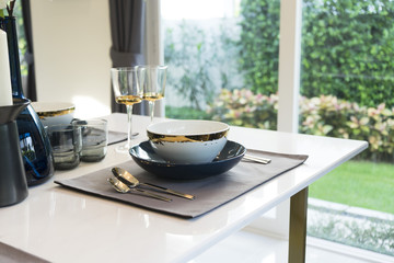 dining table and comfortable chairs in modern home with elegant table setting