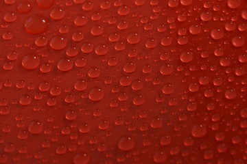 water drops on red background texture