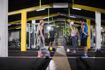 athletes doing exercises with kettlebells