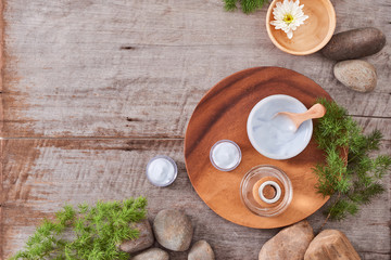 Preparing handmade hydrating natural gel and anti-aging cosmetic from extract of aloe vera leaves with pebbles and wooden background for zen beauty, top view