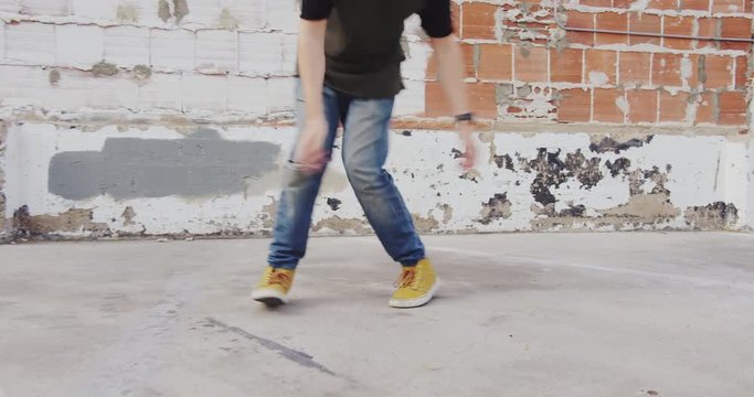 Hip hop dancer freestyling outside in city
