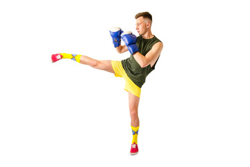 A young guy kicks. Isolated on white background. Side view.
