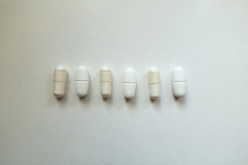 Top view of white capsules of magnesium citrate and caplets of calcium citrate