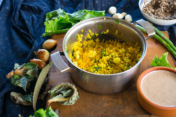 Pot with cooked bulgur wheat grain porridge with turmeric powder, garlic and spices served for lunch or dinner. Traditional arabic, asian, middle east. Vegan vegetarian healthy food