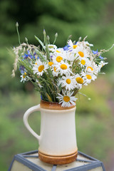 Midsummer in Latvia: celebration of Ligo in june decorating home with field flower bouquet