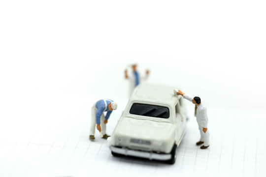 Miniature people : Professional painting car in a paint chamber during.