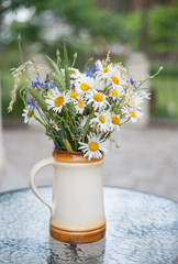 Midsummer in Latvia: celebration of Ligo in june decorating home with field flower bouquet