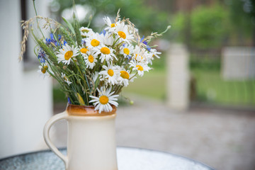 Midsummer in Latvia: celebration of Ligo in june decorating home with field flower bouquet