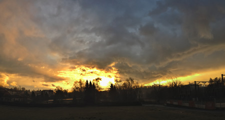 A fiery sunset over the countryside in winter.