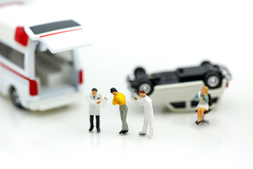 Miniature people : Doctor and Paramedic attending to patient in ambulance,Medicine ambulance concept