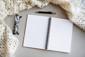 Selective focus table : Businessman hand write notebook, mobile phone, laptop, and pen on the...