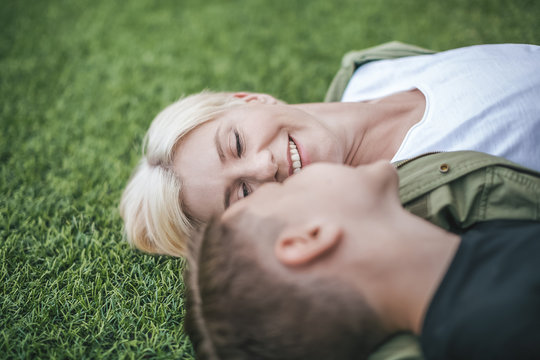 close-up view of happy mother and son lying together on grass, selective focus