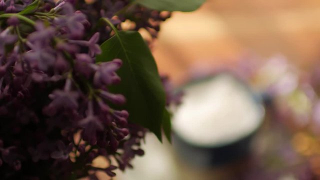 close-up, a bouquet of lilac and hot coffee