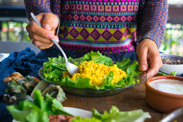 Woman hands holds cooked bulgur wheat grain porridge with turmeric powder, garlic and spices served for lunch or dinner. Traditional arabic, asian food. Vegan vegetarian healthy food