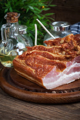 Raw bacon on a chopping board.