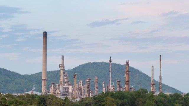Time lapse of oil refinery petrochemical industry plant in sunset, day to night