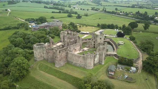 Aerial drone view of the ruins of a medieval castle (Raglan Castle, Wales)