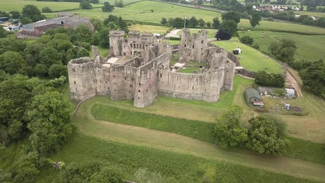 Aerial drone view of the ruins of a medieval castle (Raglan Castle, Wales)