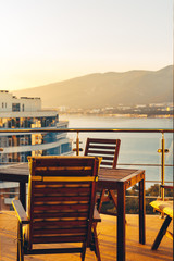Summer Outdoor Balcony With Garden Furniture In Sea And Sunset Overview. Penthouse Apartments Resort Recreation Summer Concept